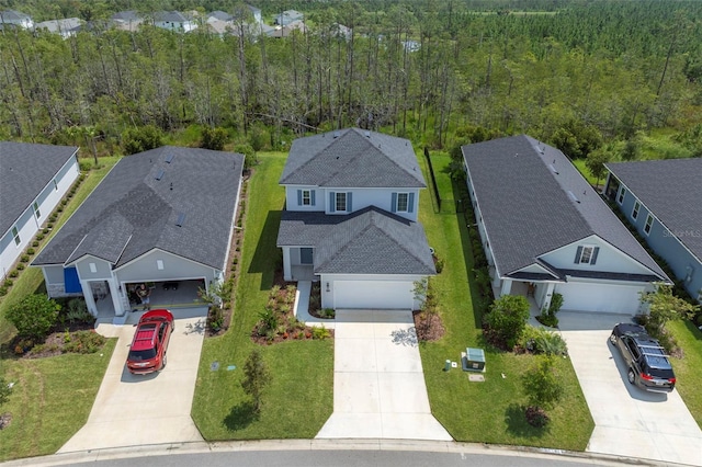 bird's eye view with a wooded view