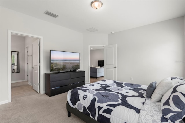 bedroom with visible vents, baseboards, and light colored carpet