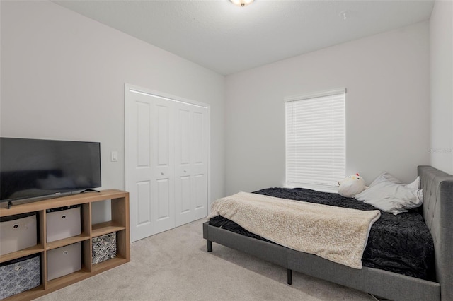 carpeted bedroom with a closet