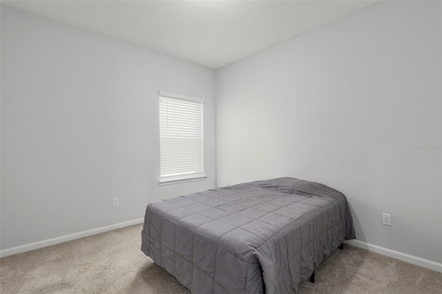 carpeted bedroom featuring baseboards