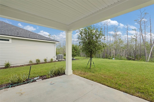 view of yard featuring cooling unit and a patio