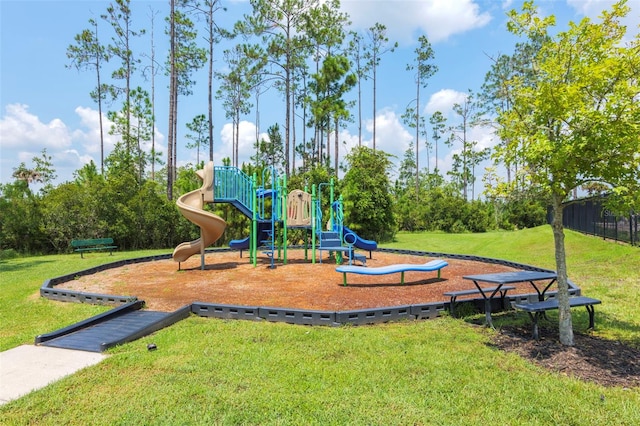 community jungle gym featuring a yard