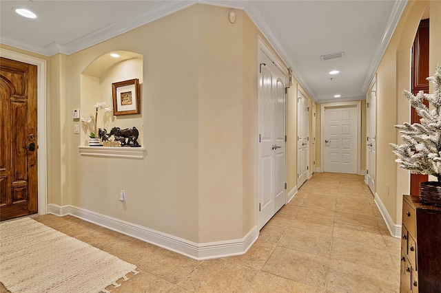 corridor with light tile patterned floors, baseboards, visible vents, recessed lighting, and crown molding