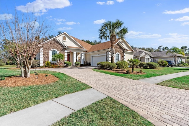 view of front of house with a front yard, stucco siding, decorative driveway, a garage, and stone siding