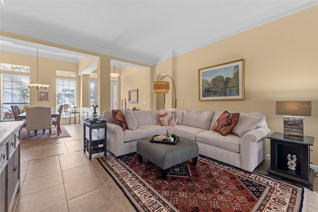 living area with light tile patterned floors and crown molding