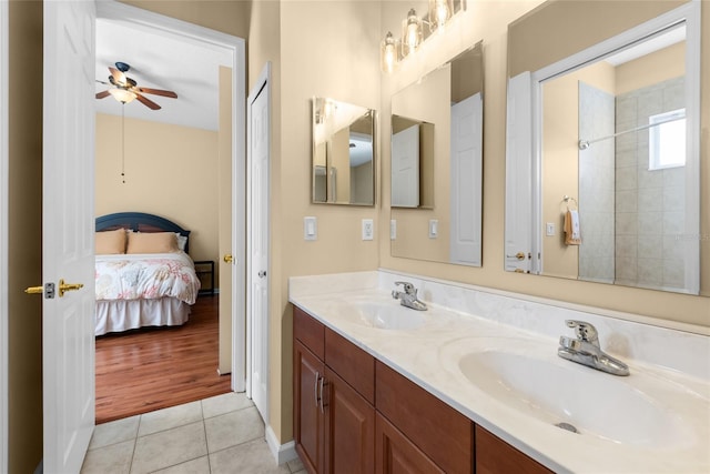 bathroom with tile patterned flooring, double vanity, ensuite bathroom, and a sink