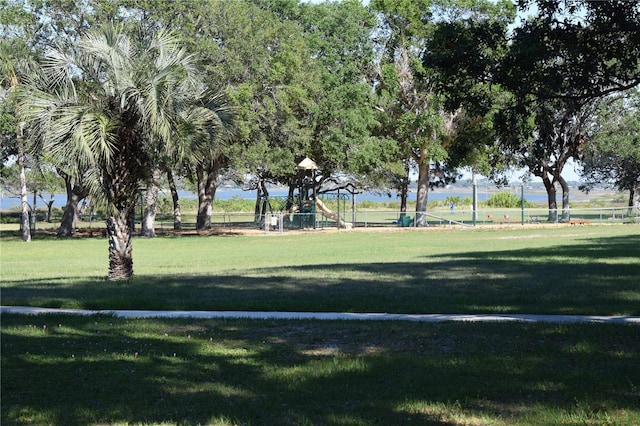 view of home's community featuring a yard and playground community