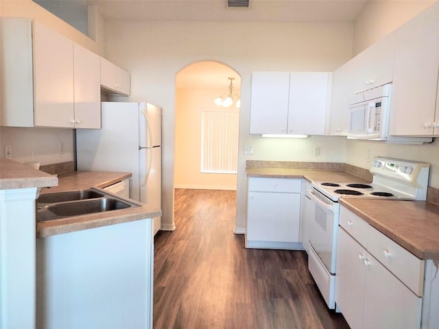 kitchen with dark wood finished floors, white appliances, white cabinetry, and a sink