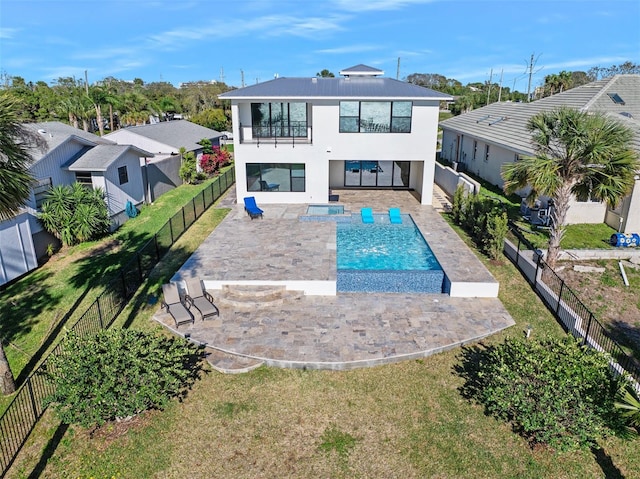 back of property featuring a patio, a balcony, a fenced backyard, and stucco siding