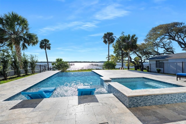 view of swimming pool with a patio, fence, a water view, and a pool with connected hot tub