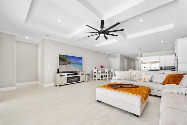 living room with recessed lighting, a ceiling fan, light wood-type flooring, and coffered ceiling