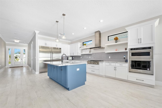 kitchen with open shelves, a sink, decorative backsplash, appliances with stainless steel finishes, and white cabinetry