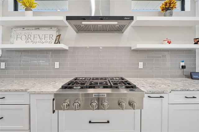 kitchen featuring stainless steel gas stovetop, white cabinets, extractor fan, and open shelves