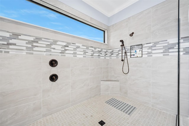 bathroom featuring tiled shower and ornamental molding