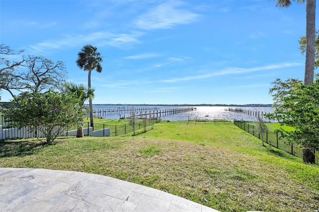 view of yard featuring fence and a water view