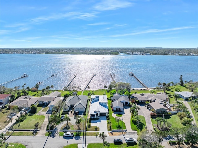 drone / aerial view featuring a residential view and a water view