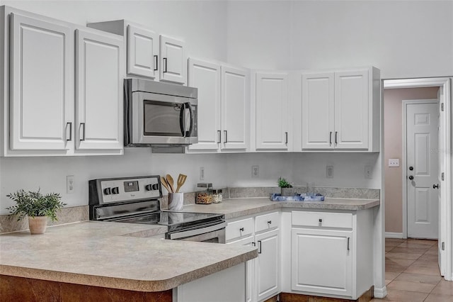 kitchen with white cabinetry, light countertops, and stainless steel appliances