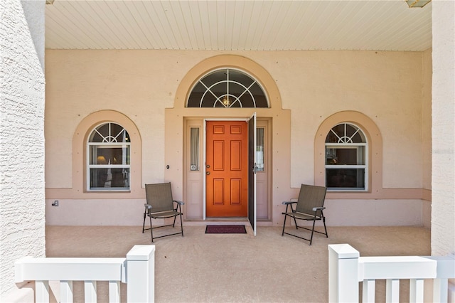 property entrance featuring stucco siding