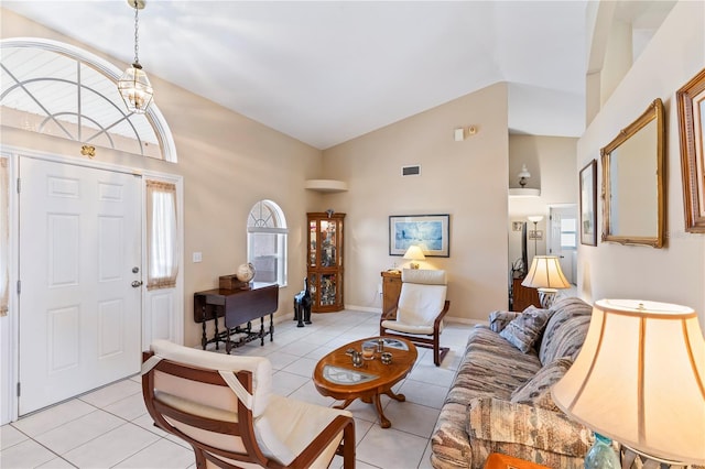 foyer featuring light tile patterned floors, visible vents, a notable chandelier, and baseboards