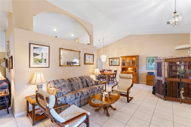 living room with light tile patterned floors, baseboards, lofted ceiling, and an inviting chandelier