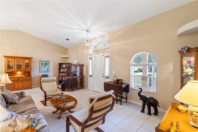 living area with lofted ceiling, light tile patterned floors, and baseboards