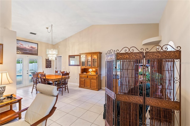 dining space featuring light tile patterned floors, visible vents, high vaulted ceiling, french doors, and a chandelier