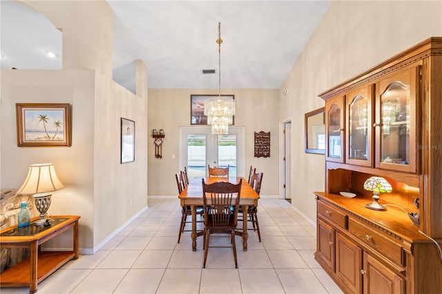 dining space with visible vents, an inviting chandelier, light tile patterned floors, baseboards, and vaulted ceiling