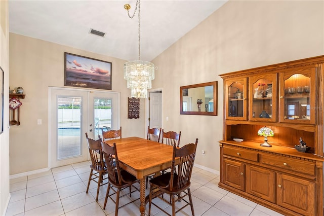 dining space featuring visible vents, high vaulted ceiling, an inviting chandelier, light tile patterned flooring, and french doors