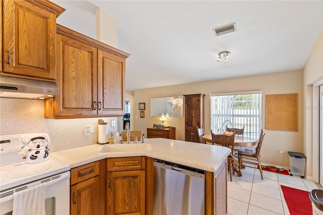 kitchen featuring visible vents, range hood, stainless steel dishwasher, electric stove, and a sink