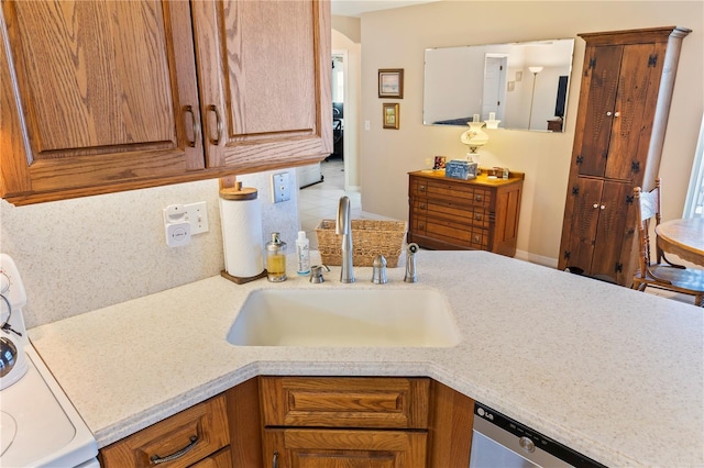 kitchen with a sink, light countertops, stove, stainless steel dishwasher, and brown cabinets