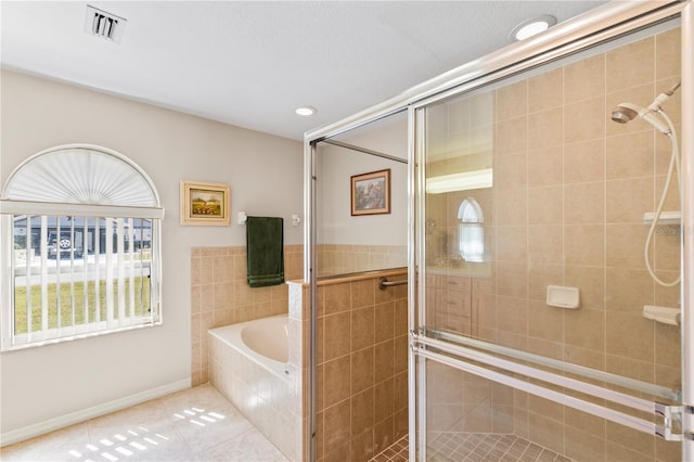 bathroom featuring baseboards, visible vents, a stall shower, tile patterned floors, and a bath