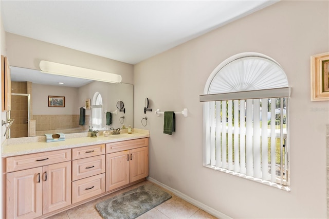 bathroom featuring baseboards, tiled shower, vanity, and tile patterned flooring