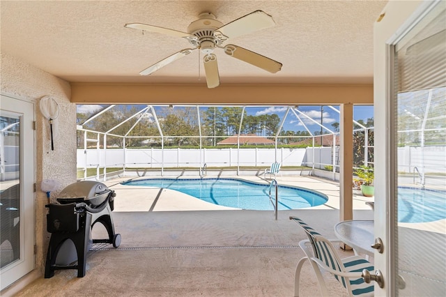 view of pool with a lanai, a fenced backyard, and a patio area