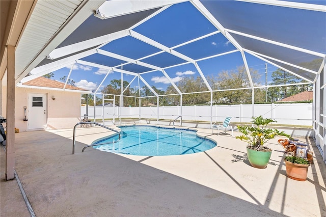 view of pool featuring a patio area, a fenced in pool, glass enclosure, and a fenced backyard