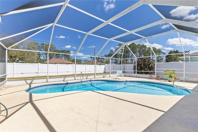 view of pool featuring glass enclosure, a fenced in pool, a fenced backyard, and a patio area