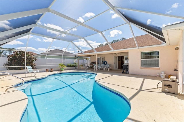 outdoor pool featuring a patio area, a lanai, ceiling fan, and fence