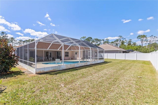 back of house featuring a fenced in pool, a lanai, a lawn, a fenced backyard, and a patio area