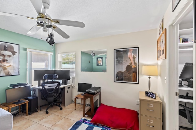 office with a textured ceiling, light tile patterned flooring, and ceiling fan