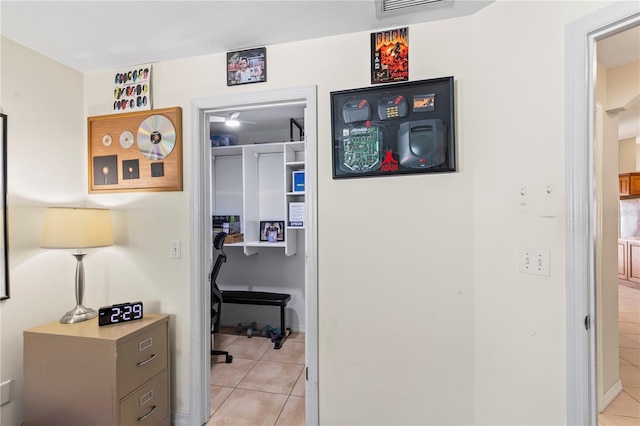 hallway featuring light tile patterned floors and visible vents