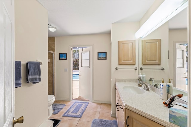 full bath featuring tile patterned floors, toilet, a stall shower, and vanity