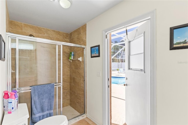 bathroom with a stall shower and toilet