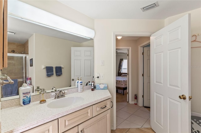 full bathroom with tile patterned flooring, visible vents, a shower stall, ensuite bathroom, and vanity