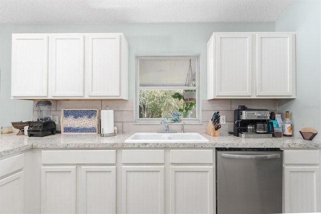 kitchen with dishwasher, white cabinetry, light countertops, and a sink