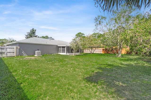 view of yard with a fenced backyard and a sunroom