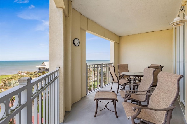 balcony featuring a water view and a view of the beach