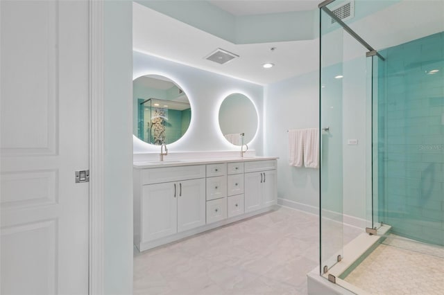 bathroom featuring a shower stall, double vanity, visible vents, and a sink