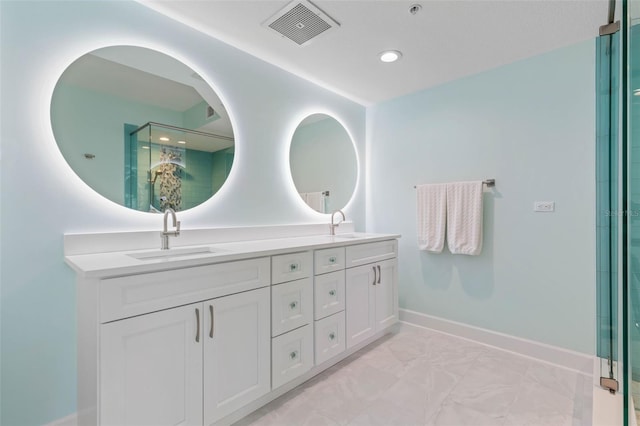 bathroom featuring visible vents, a sink, a shower stall, double vanity, and baseboards