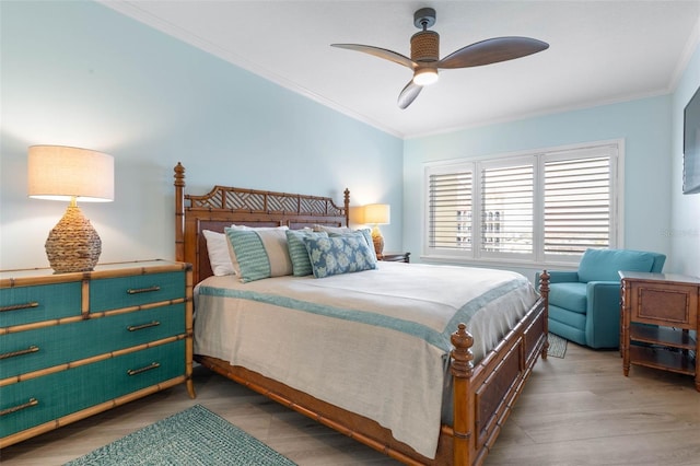 bedroom with crown molding, a ceiling fan, and wood finished floors