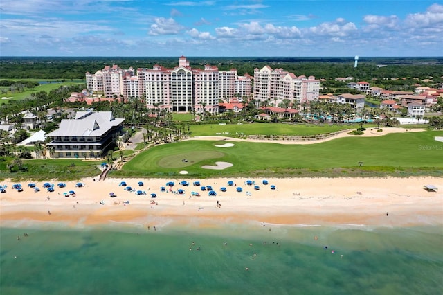 bird's eye view featuring a water view, view of golf course, a view of city, and a view of the beach