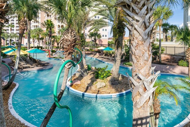 view of pool featuring fence